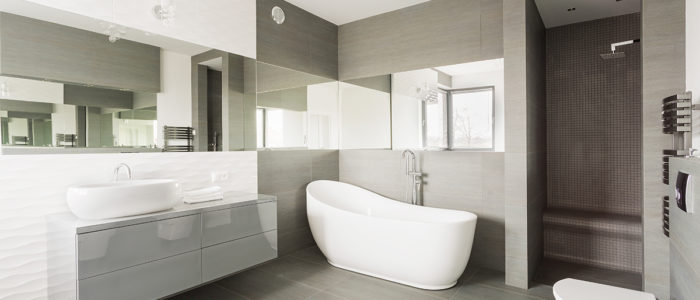White and grey exclusive big washroom with fancy bath